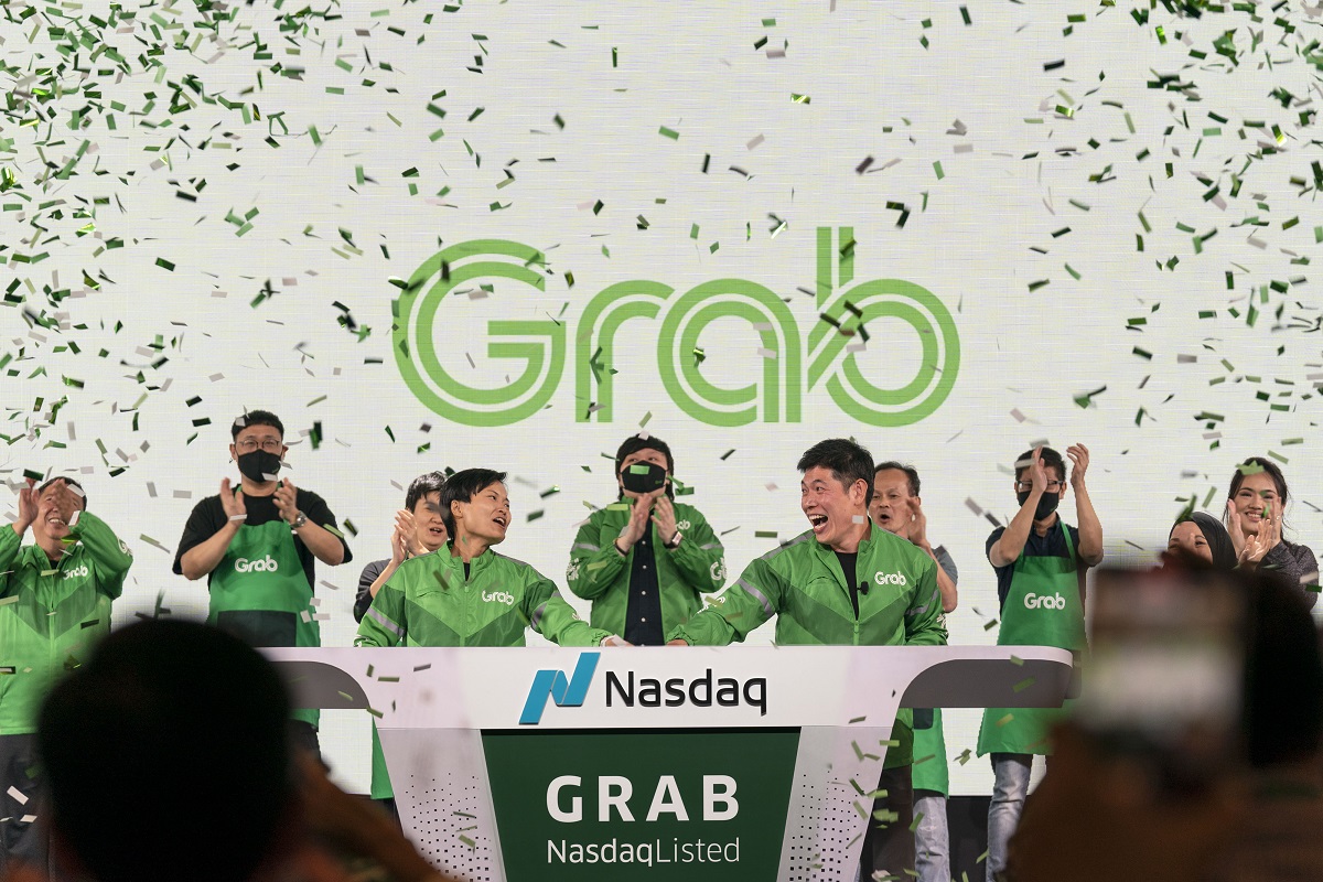 Grab group chief executive officer and co-founder Anthony Tan (front right) and co-founder Tan Hooi Ling (front left) ringing the opening bell in Singapore as Grab went public on the Nasdaq on Thursday (Dec 2).