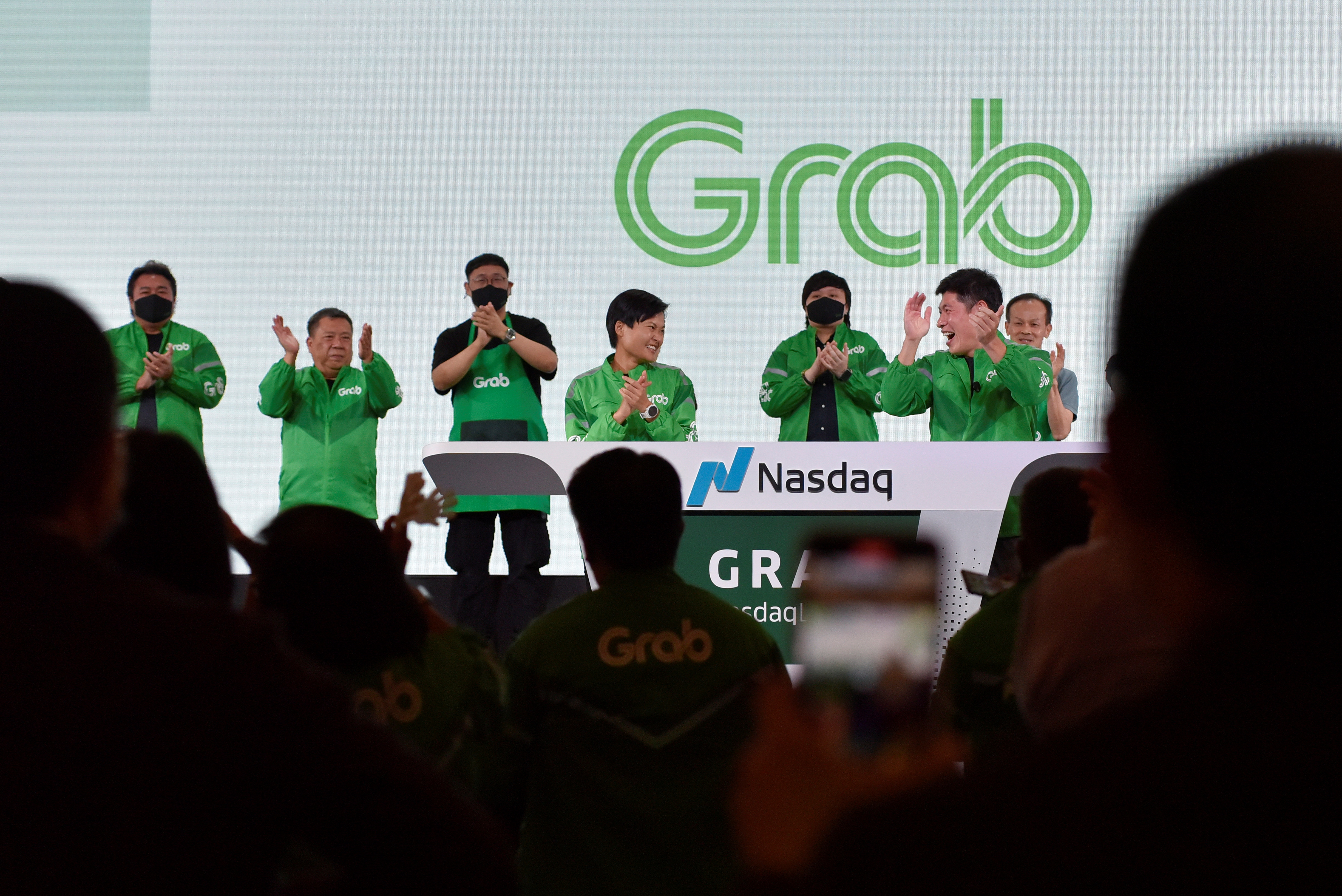 Nasdaq debut: Grab's CEO Anthony Tan and co-founder Tan Hooi Ling gestures on stage as they attend the Grab Bell Ringing Ceremony at a hotel in Singapore on Thursday Dec 2, 2021. (Photo by Caroline Chia/Reuters)