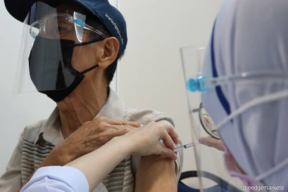 A man receives his Covid-19 vaccine dose at the MITEC vaccination centre on Monday, May 31, 2021. (Photo by Zahid Izzani/The Edge)