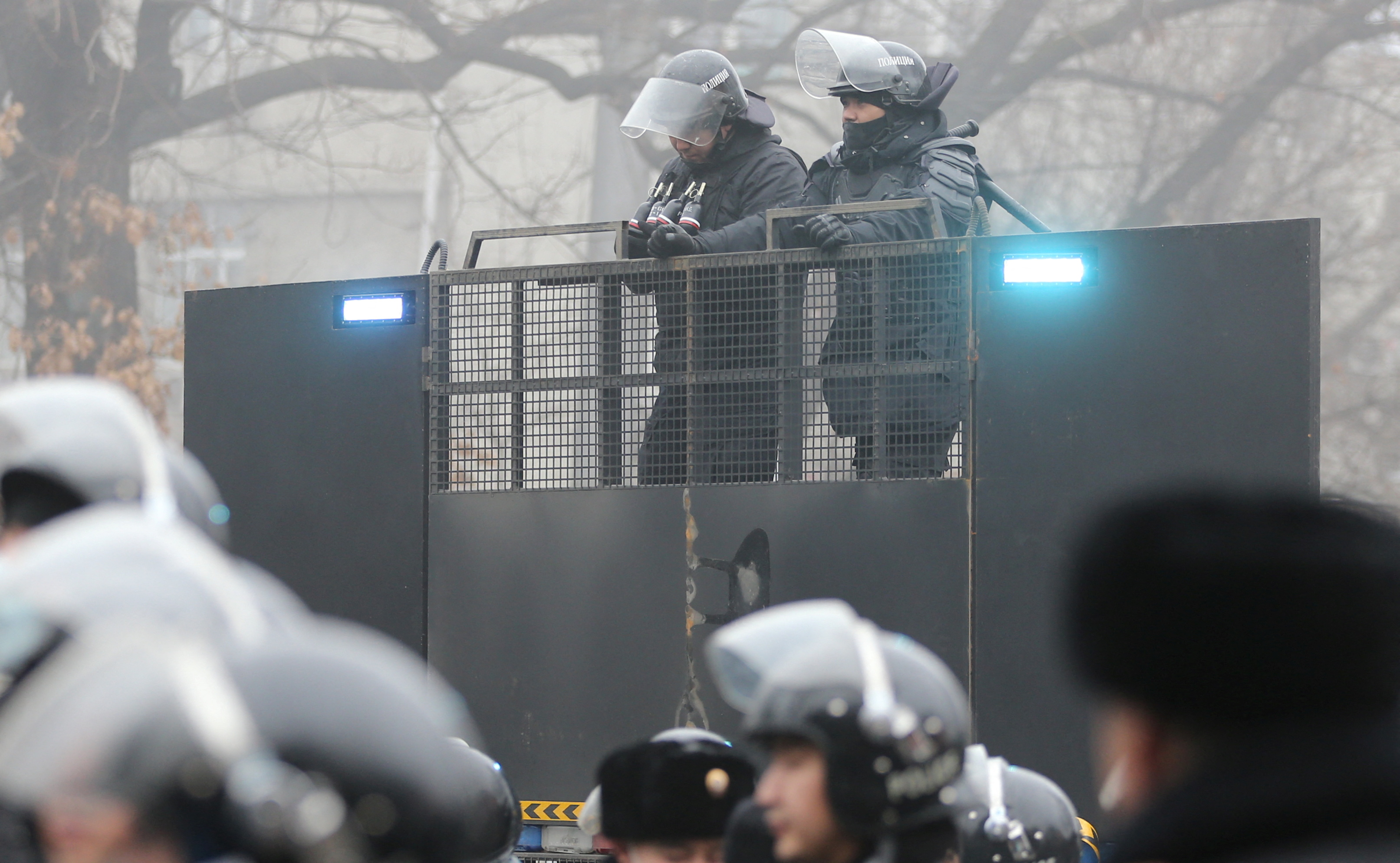 Kazakh law enforcement officers are seen on a barricade during a protest triggered by fuel price increase in Almaty, Kazakhstan January 5, 2022.