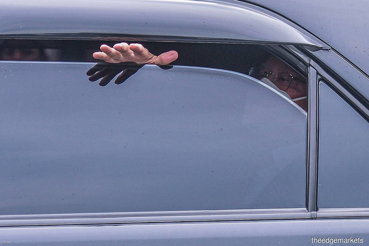 Najib, in a black vehicle, managed to give his supporters a small wave from a heavily-tinted window that was partly wound down. (Photos by Zahid Izzani Mohd Said/The Edge)