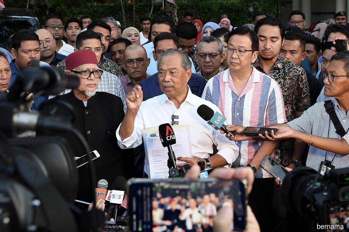 Perikatan Nasional chairman Tan Sri Muhyiddin Yassin (centre) speaking at a press conference held at his residence in Bukit Damansara, Kuala Lumpur on Nov 22, 2022.