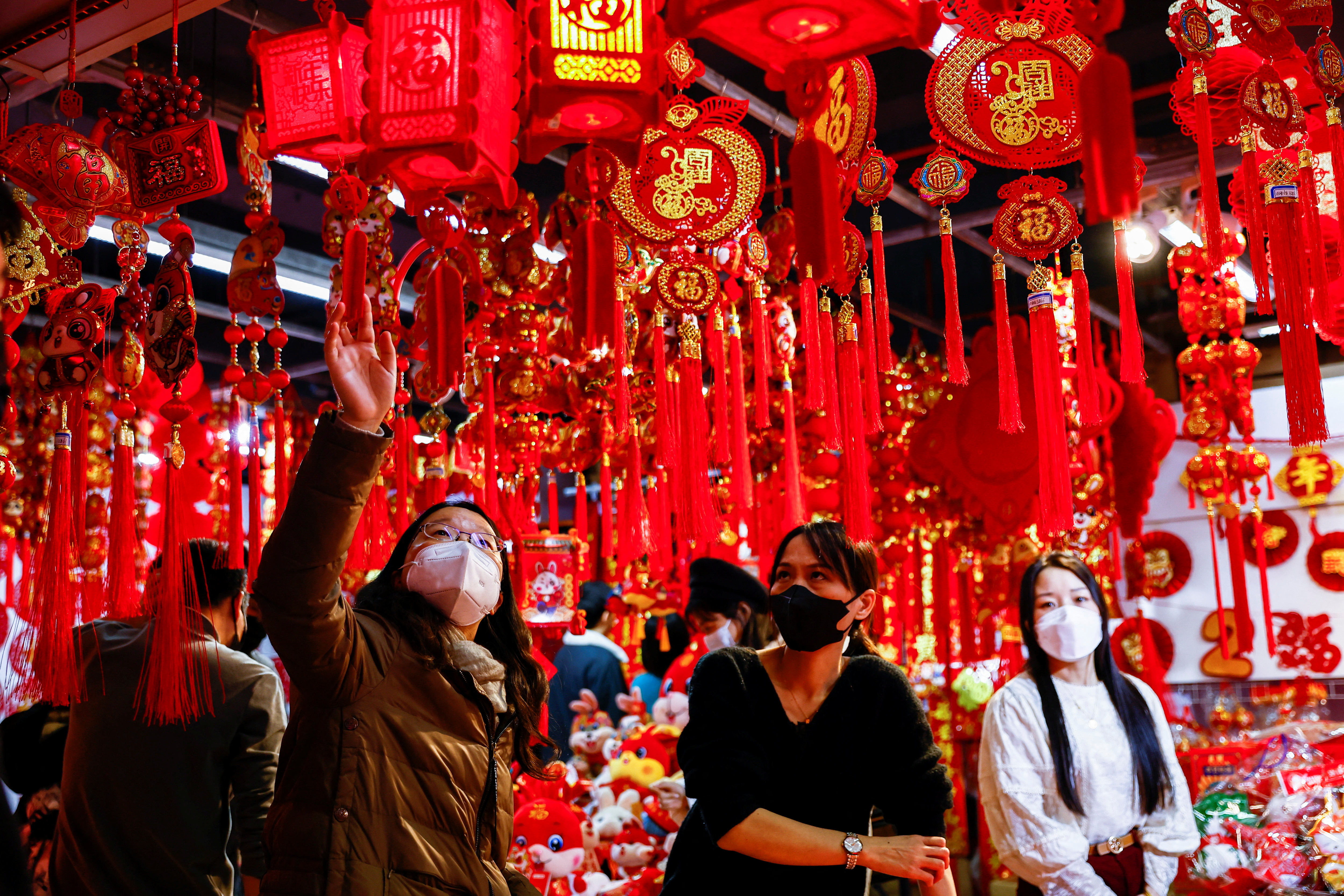 A customer looks at decorations for the Chinese Lunar New Year at a market selling Spring Festival ornaments ahead of the Chinese Lunar New Year festivity, in Beijing, China on January 7, 2023. (Reuters)