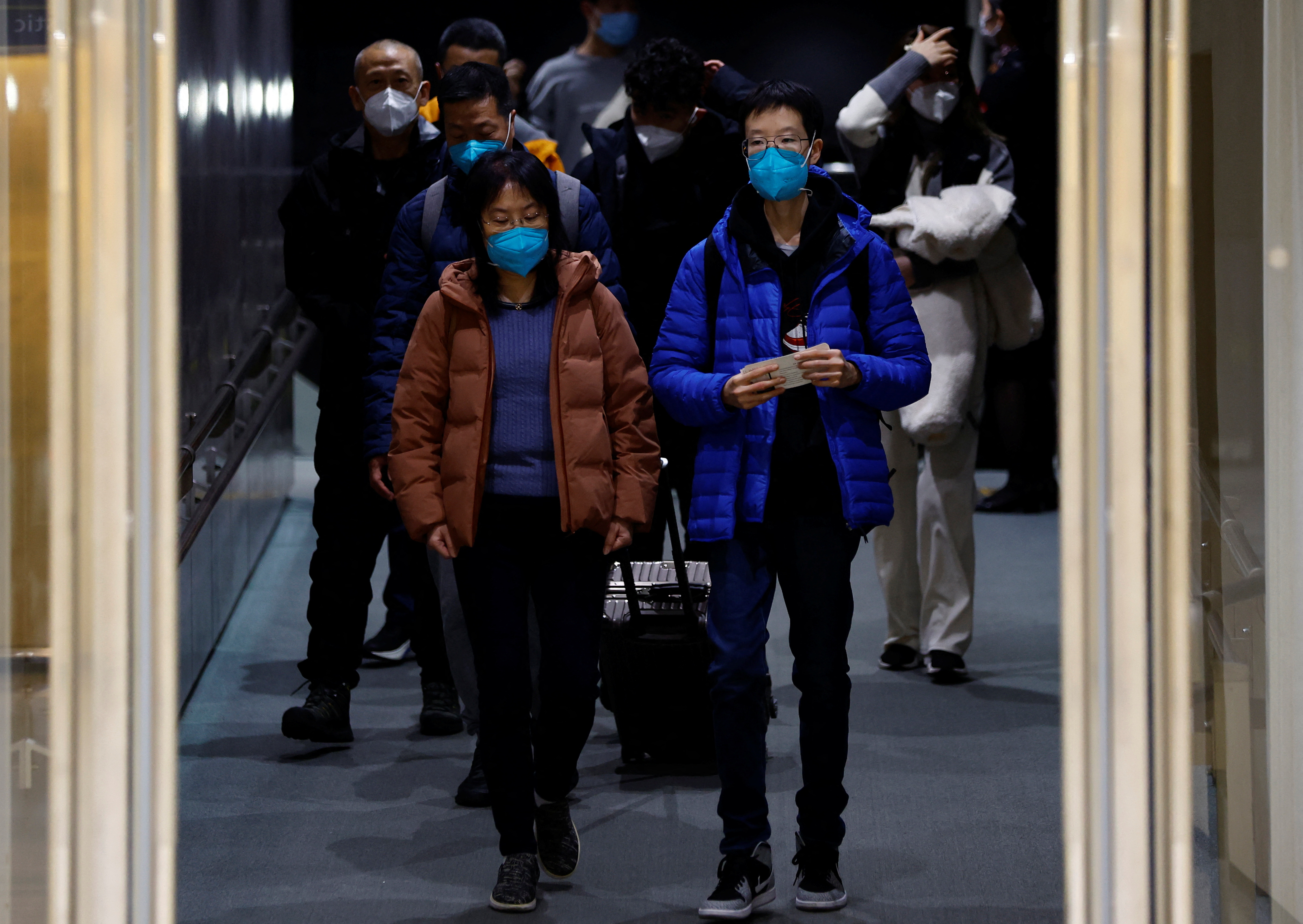 Passengers on a plane from China’s capital Beijing arrive at Narita international airport in Narita, east of Tokyo, Japan on January 8, 2023. (Reuters)