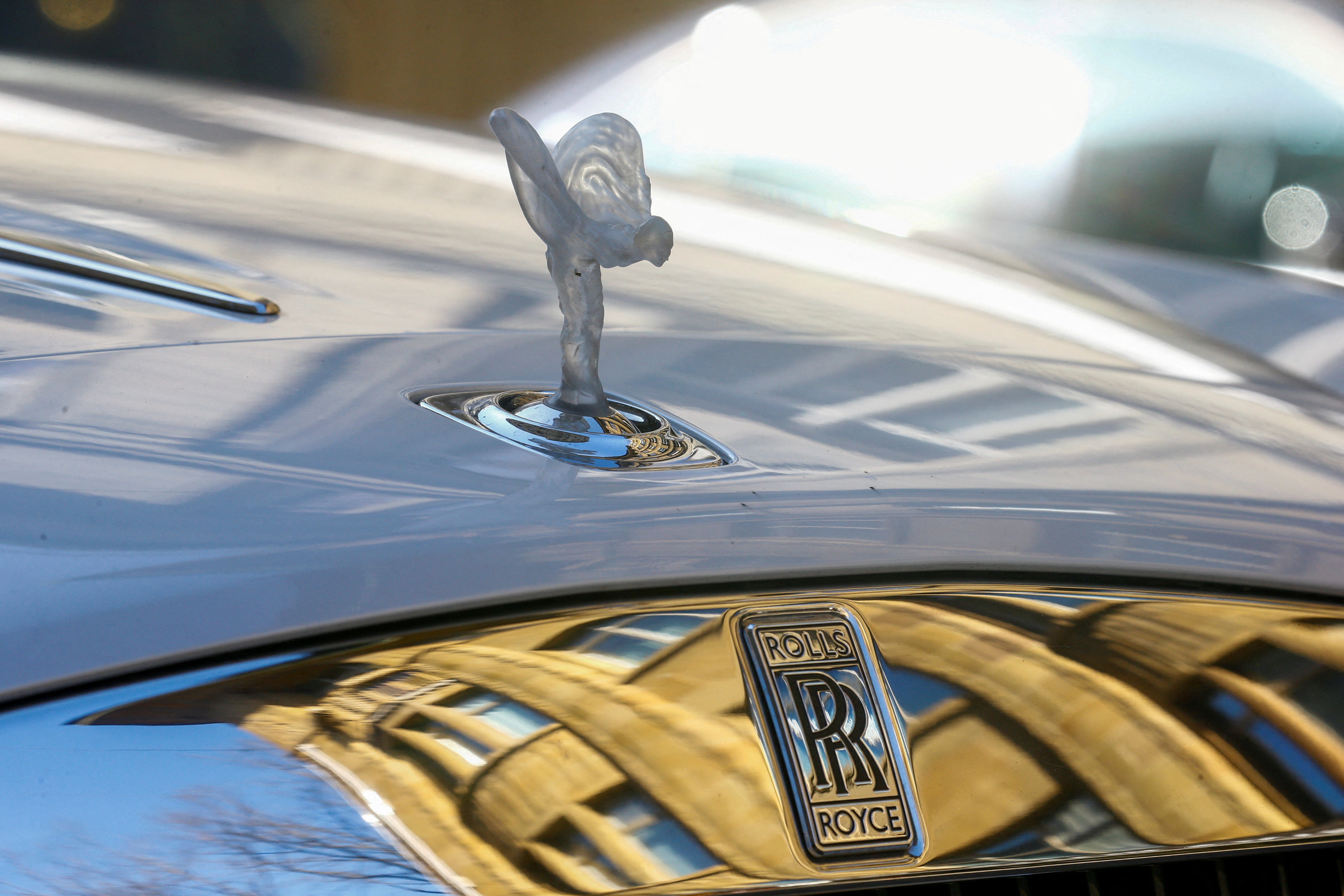 The mascot, the so-called 'Spirit of Ecstasy' or 'Emily', and the company logo are seen on the bonnet of a Rolls-Royce car in Zurich, Switzerland on March 30, 2021. (Reuters)