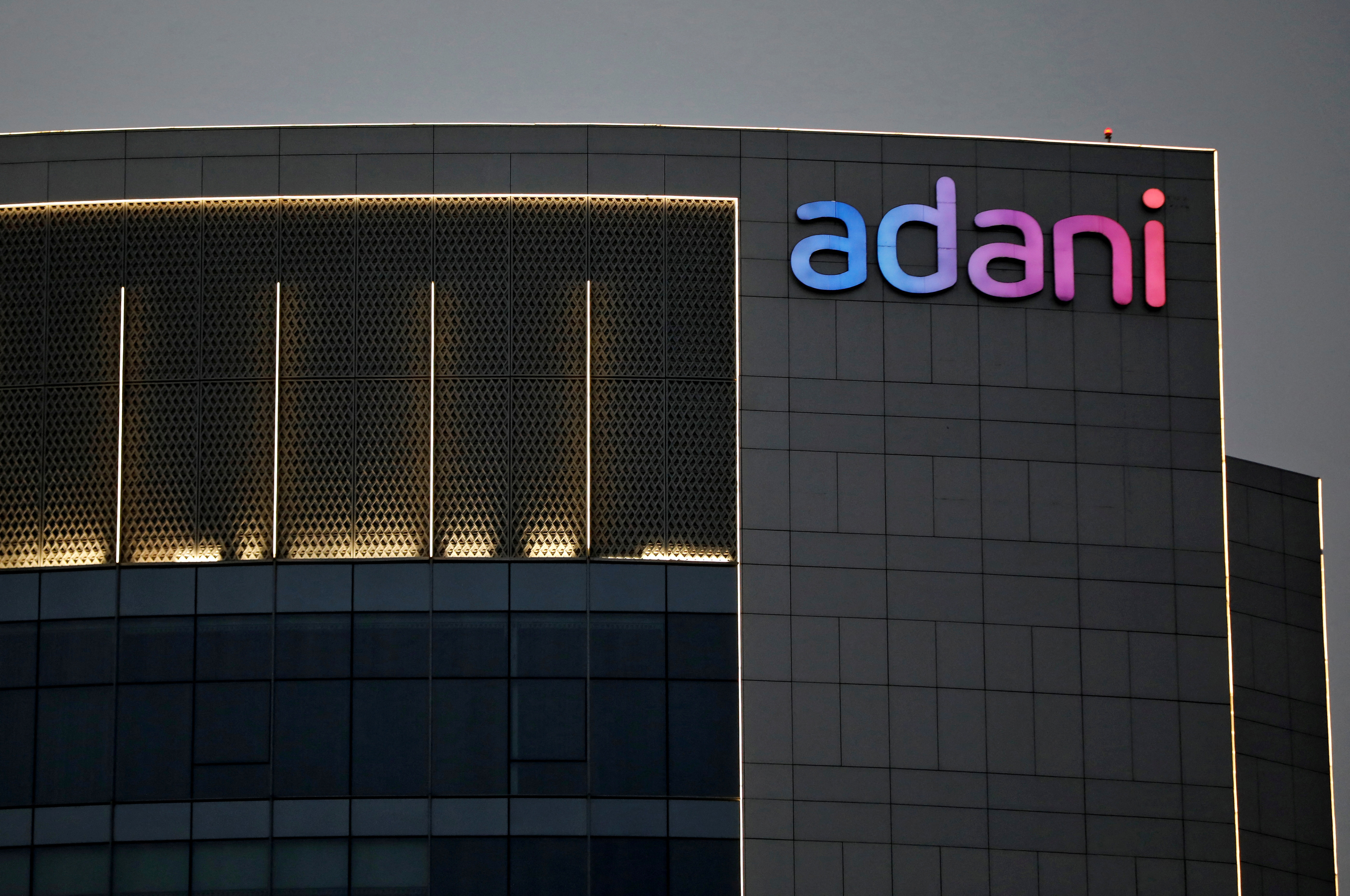 The logo of the Adani Group is seen on the facade of one of its buildings on the outskirts of Ahmedabad, India, on April 13, 2021. (Reuters)