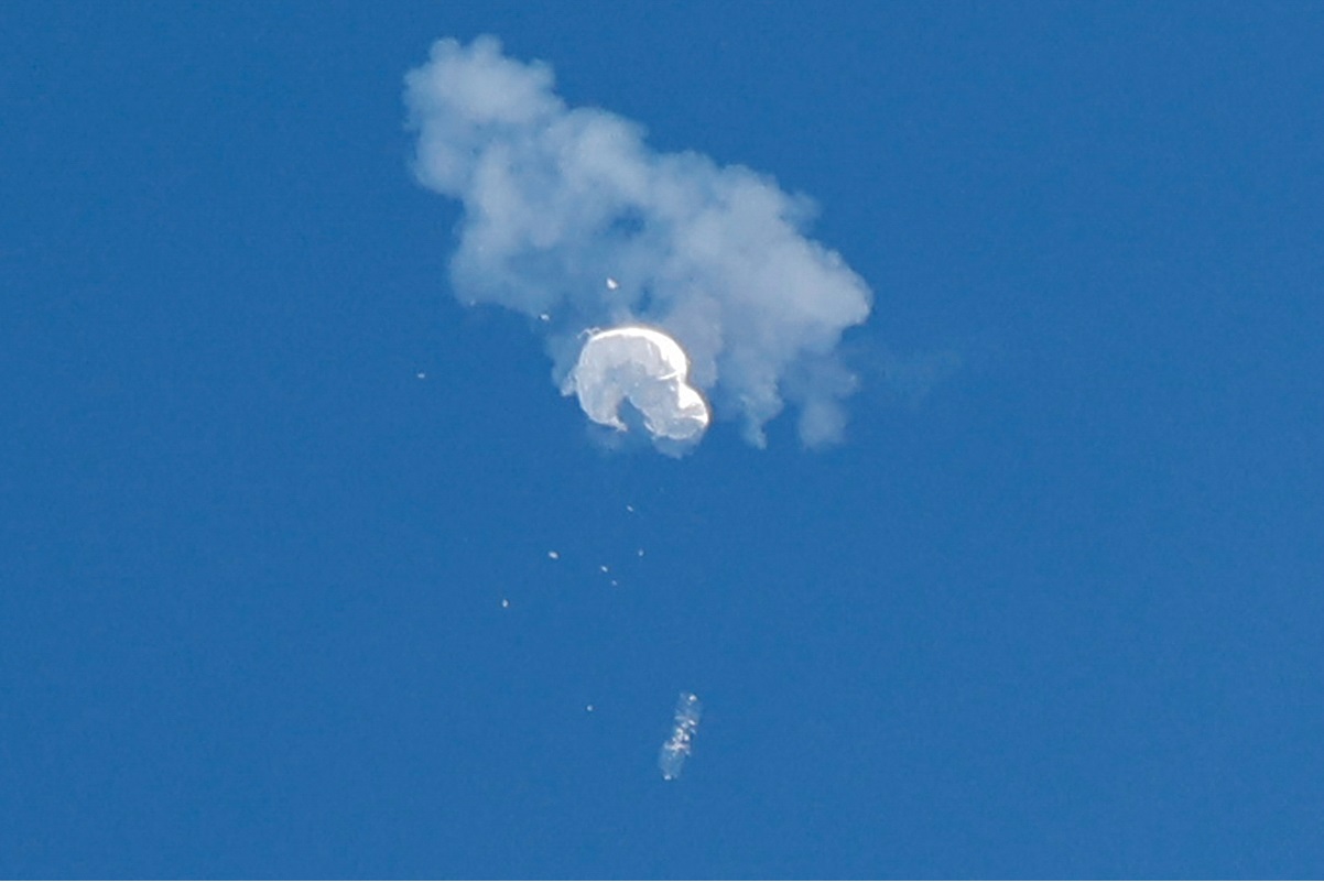 The suspected Chinese spy balloon drifts to the ocean after being shot down off the coast in Surfside Beach, South Carolina, US. (Photo by Reuters)