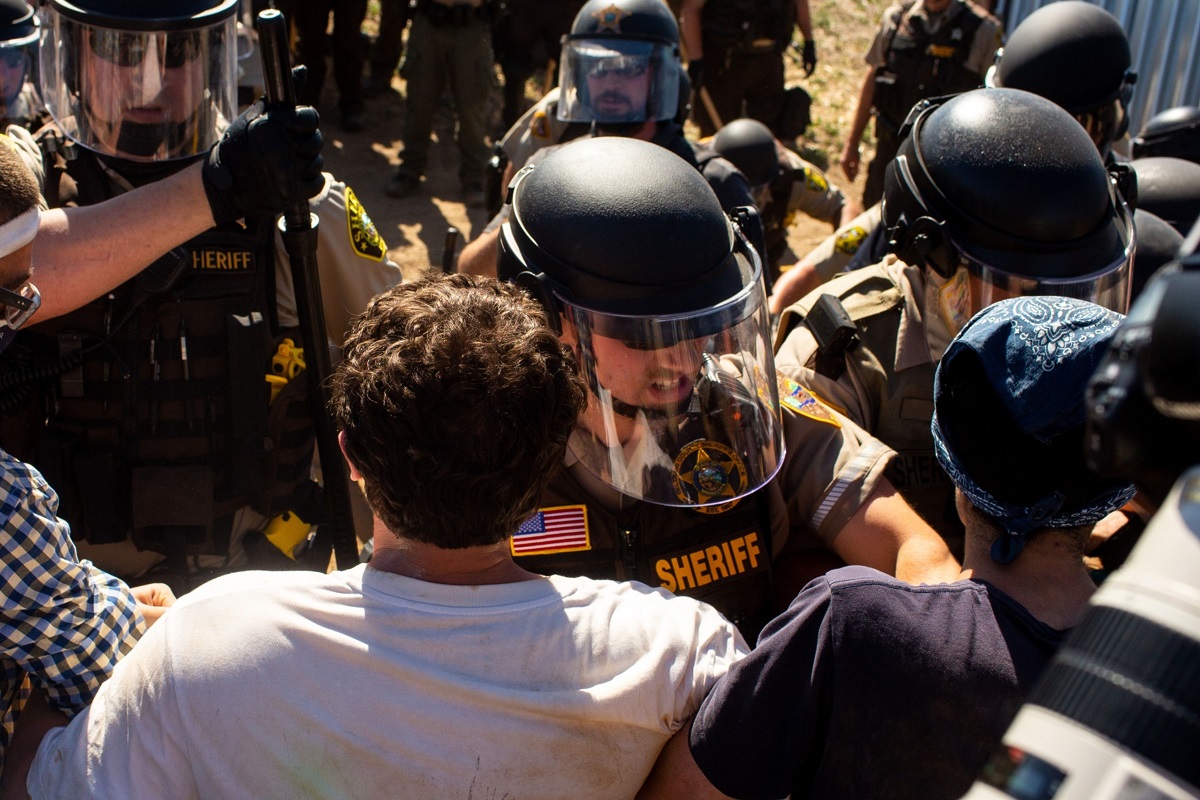Law enforcement officers clashing with demonstrators at an Enbridge Inc Line 3 pump station during a 'Treaty People Gathering' protest in Hubbard County, Minnesota, the US on June 7. (Photo by Bloomberg)