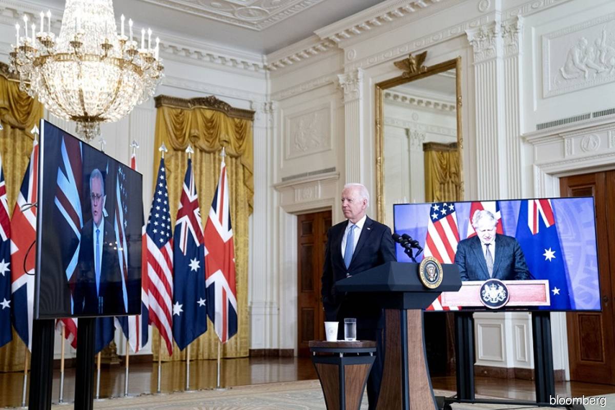 US President Joe Biden listens in the East Room of the White House in Washington, DC, US on Wednesday Sept 15, 2021, as Scott Morrison, Australia's prime minister, left, speaks via videoconference. Australia is joining a new Indo-Pacific security partnership with the US and UK that could pave the way for it to acquire nuclear-powered submarines, likely signaling the end of its deal with France to buy conventional craft.