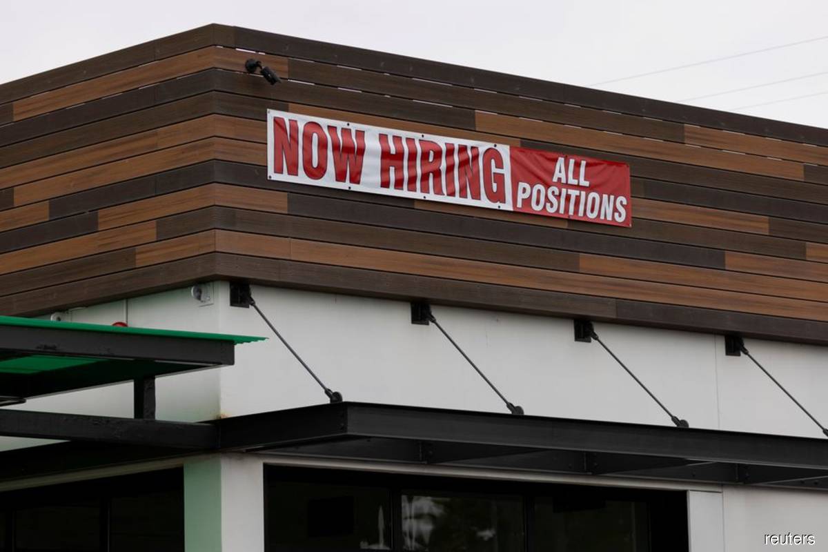 A restaurant advertising jobs looks to attract workers in Oceanside, California, US on May 10, 2021. (Photo by Mike Blake/Reuters filepix)