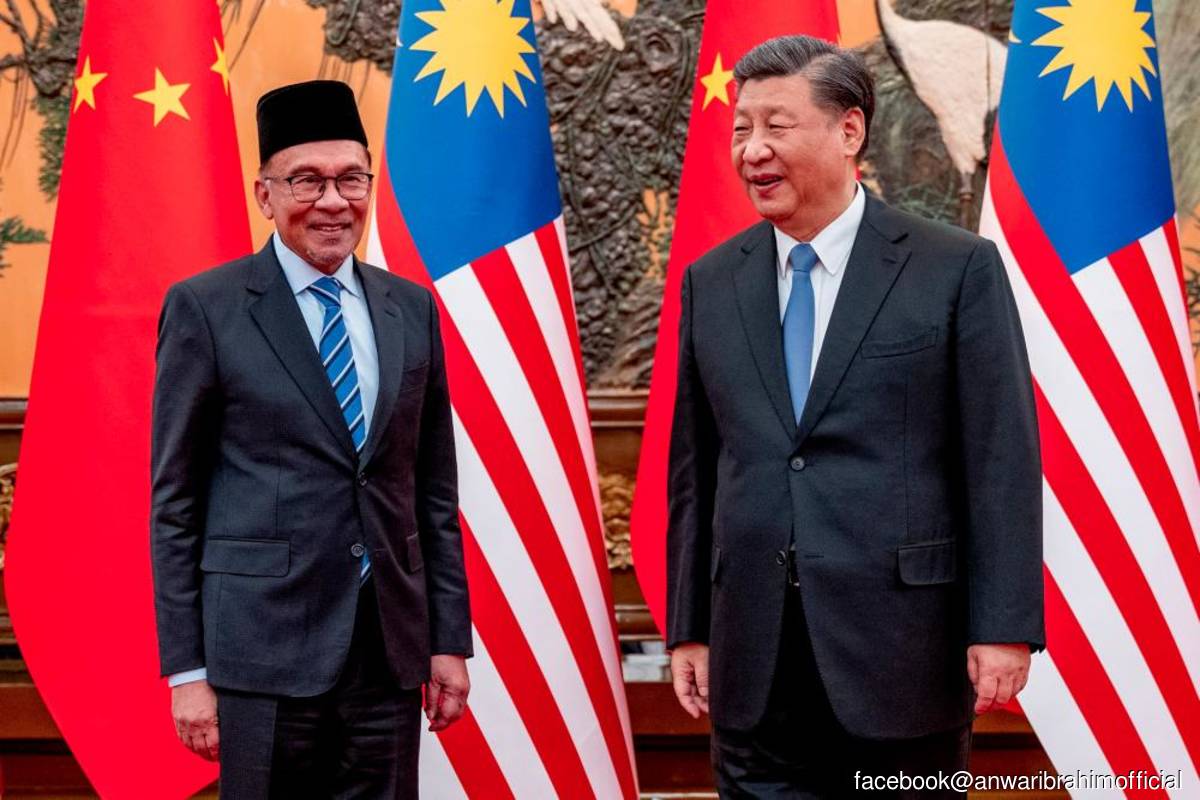 China's President Xi Jinping (right) poses with Malaysian Prime Minister Datuk Seri Anwar Ibrahim at the Great Hall of the People in Beijing, China.