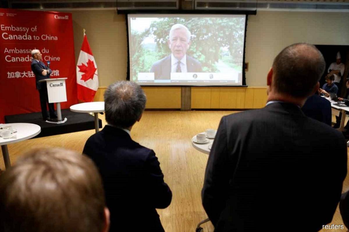 Canadian Ambassador to China, Dominic Barton, speaks to journalists and diplomats via video link from Dandong, where a local court ruled on the case of Michael Spavor, charged with espionage in June 2019, at the Canadian embassy in Beijing on Aug 11, 2021. (Reuters filepix)