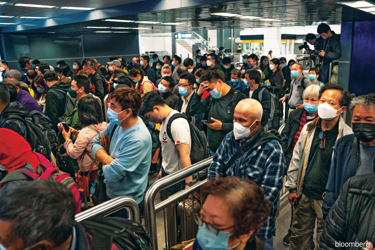 Travellers wait to enter the border control area at Lo Wu MTR station in Hong Kong, China, on Feb 6.  China’s reopening could buoy more economic activities and  be a positive catalyst for REITs. 