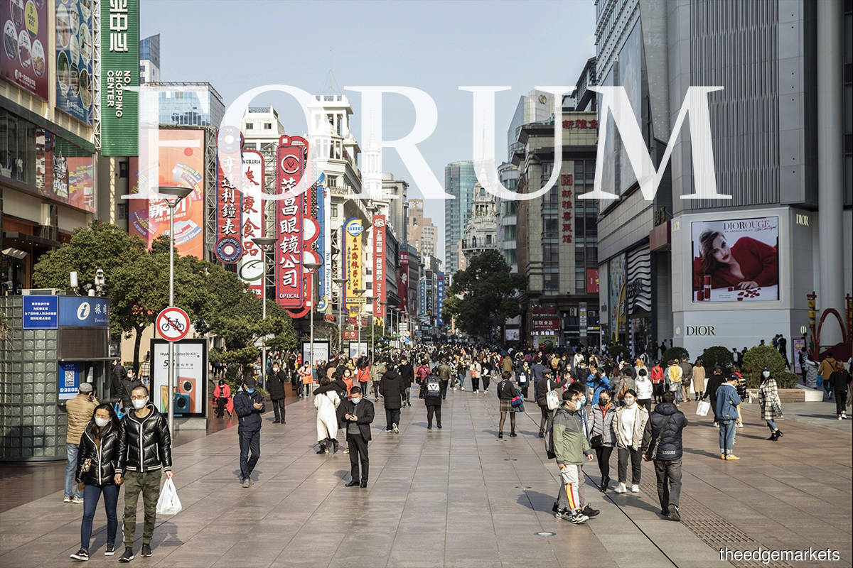 Shoppers masked up in Nanjing Road, Shanghai, last March ... China demonstrated some of its formidable strengths in the way it came through the pandemic but achieving its ‘centenary goal of fully building a modern socialist country’ will require more courageous — and sometimes risky — policy reforms
