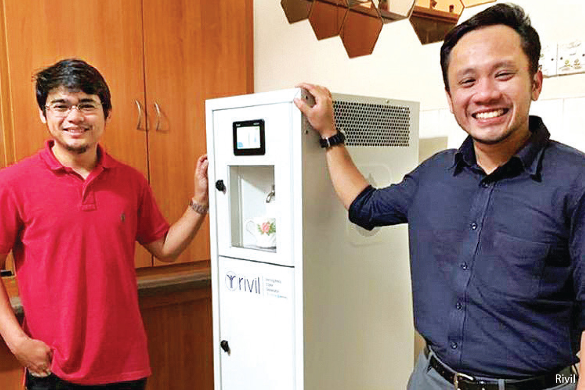 Faizal (right) with one of Rivil’s AWG machines