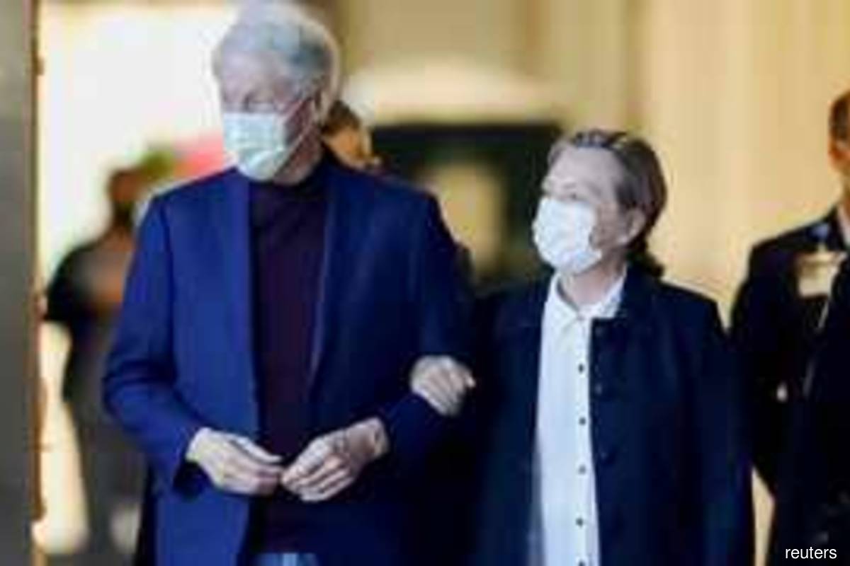 Former US President Bill Clinton, accompanied by his wife, former Secretary of State Hillary Clinton, walks out of University of California Irvine Medical Centre in US on Sunday Oct 17, 2021 (Photo by David Swanson/Reuters)