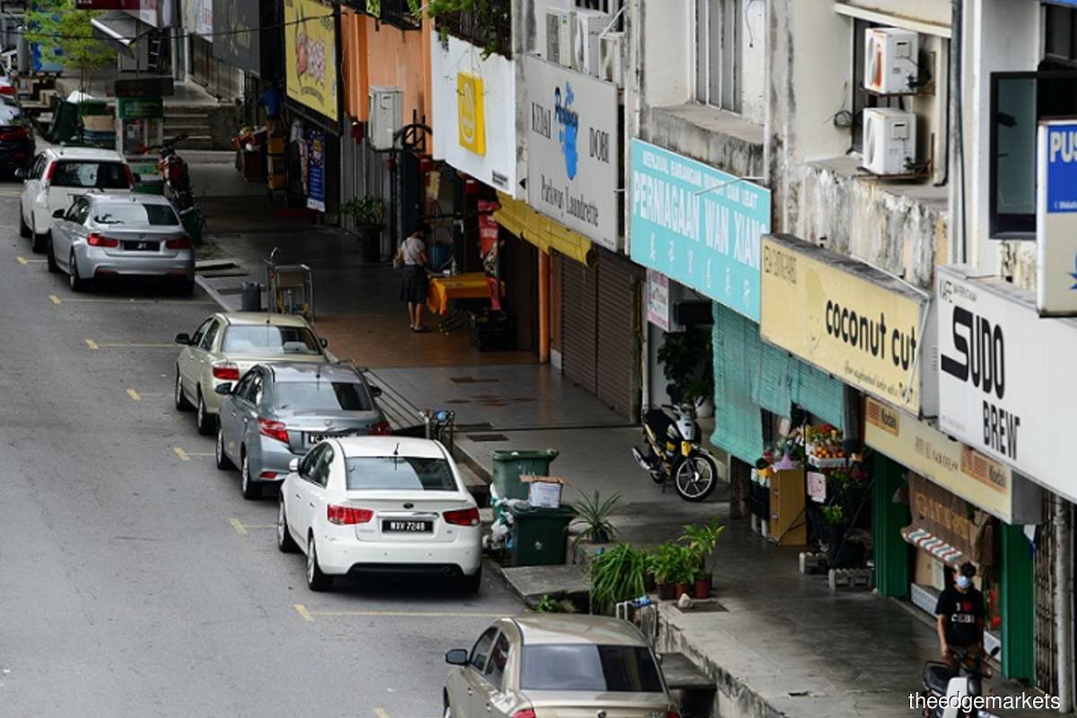 Almost empty pathways of shoplots in a Klang Valley vicinity with skeletal passerby shoppers on day 1 of MCO 2 in Malaysia, Wednesday Jan 13, 2021. (Photo credit: Patrick Goh/theedgemarkets)