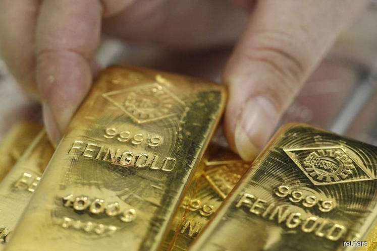 Gold bursts above $1,300 as slowdown tremors spur new year rally