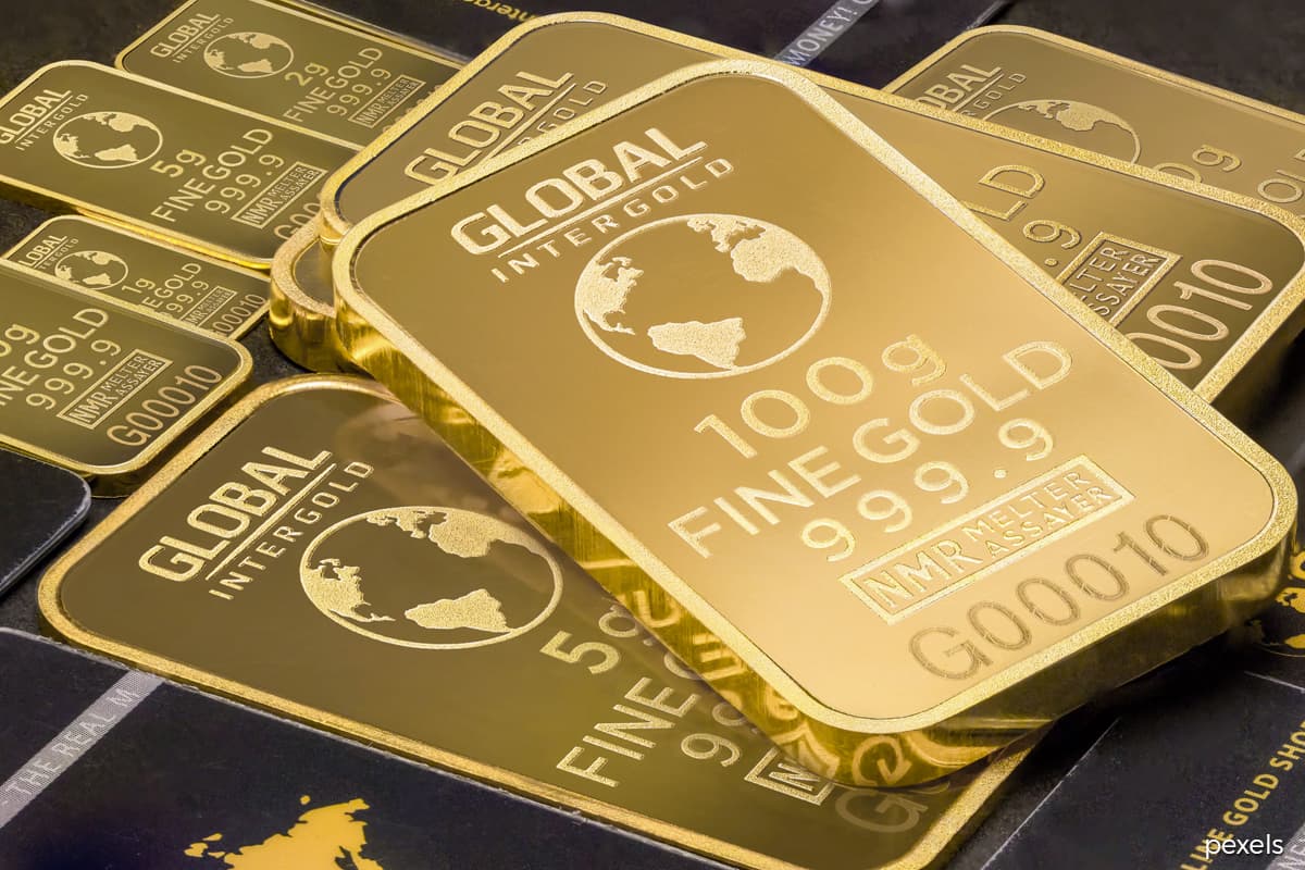 Gold eases off two-month peak as US dollar rises