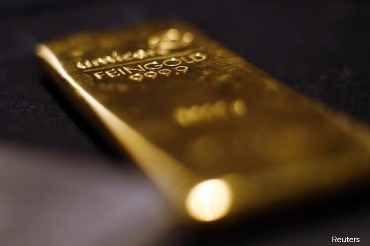 Gold down on US dollar strength, political risks lend support