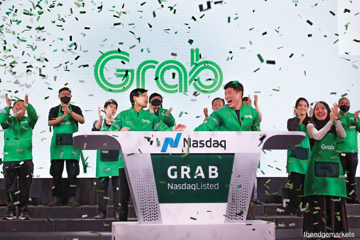 Hooi Ling and Anthony at the bell-ringing ceremony as Grab began trading on Nasdaq on Dec 2.  The company moved its headquarters to Singapore  in 2014 because of its well-developed ecosystem for start-up funding. (Photo by Bloomberg)