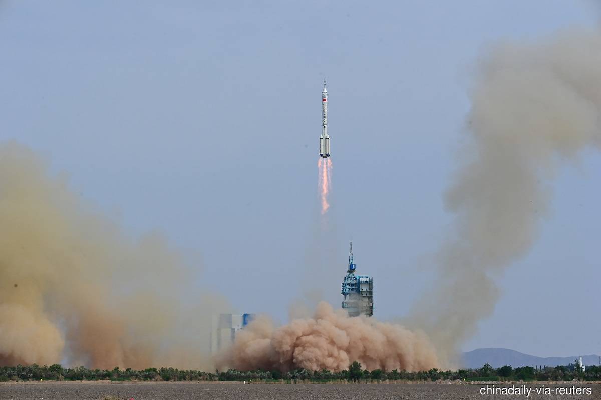 A Long March-2F carrier rocket, carrying the Shenzhou-16 spacecraft and three astronauts, takes off from the launching area of Jiuquan Satellite Launch Center for a crewed mission to China’s Tiangong space station, near Jiuquan, Gansu province, China on Tuesday, May 30, 2023. (Photo credit: China Daily via Reuters)