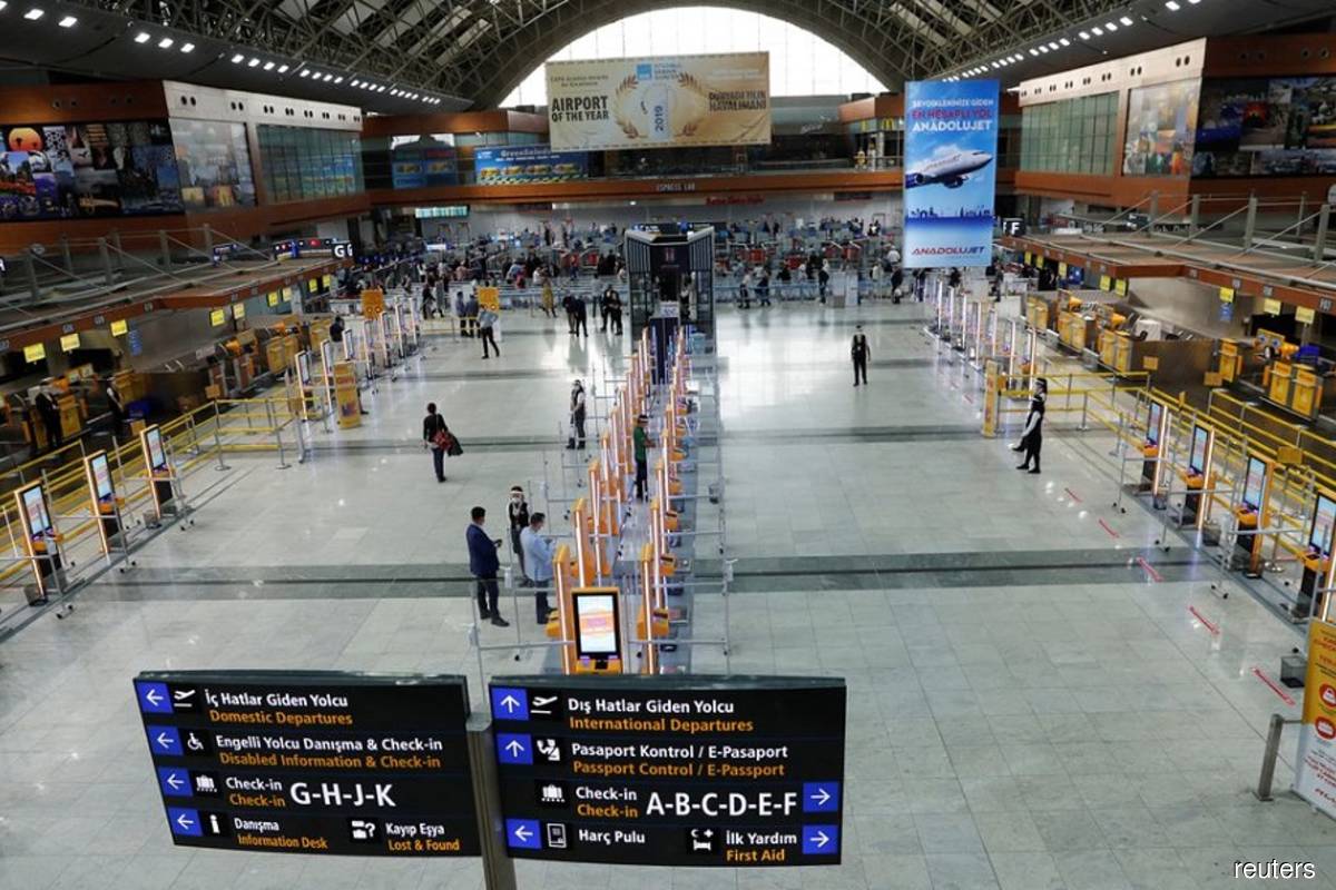 Pegasus Airlines self check-in counters are seen at the nearly empty domestic departure terminal of the Sabiha Gokcen Airport, following the coronavirus disease (Covid-19) outbreak in Istanbul, Turkey on June 11, 2020. (Reuters filepix by Murad Sezer)