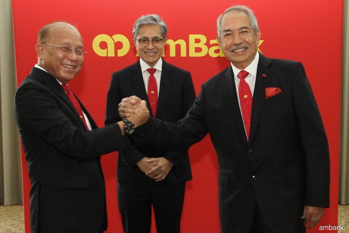 AmBank Group chairman emeritus/honorary adviser Tan Sri Azman Hashim  (left) with AmBank Group chairman Tan Sri Md Nor Yusof (right). Looking on is AmBank Group CEO Datuk Sulaiman Mohd Tahir (centre).