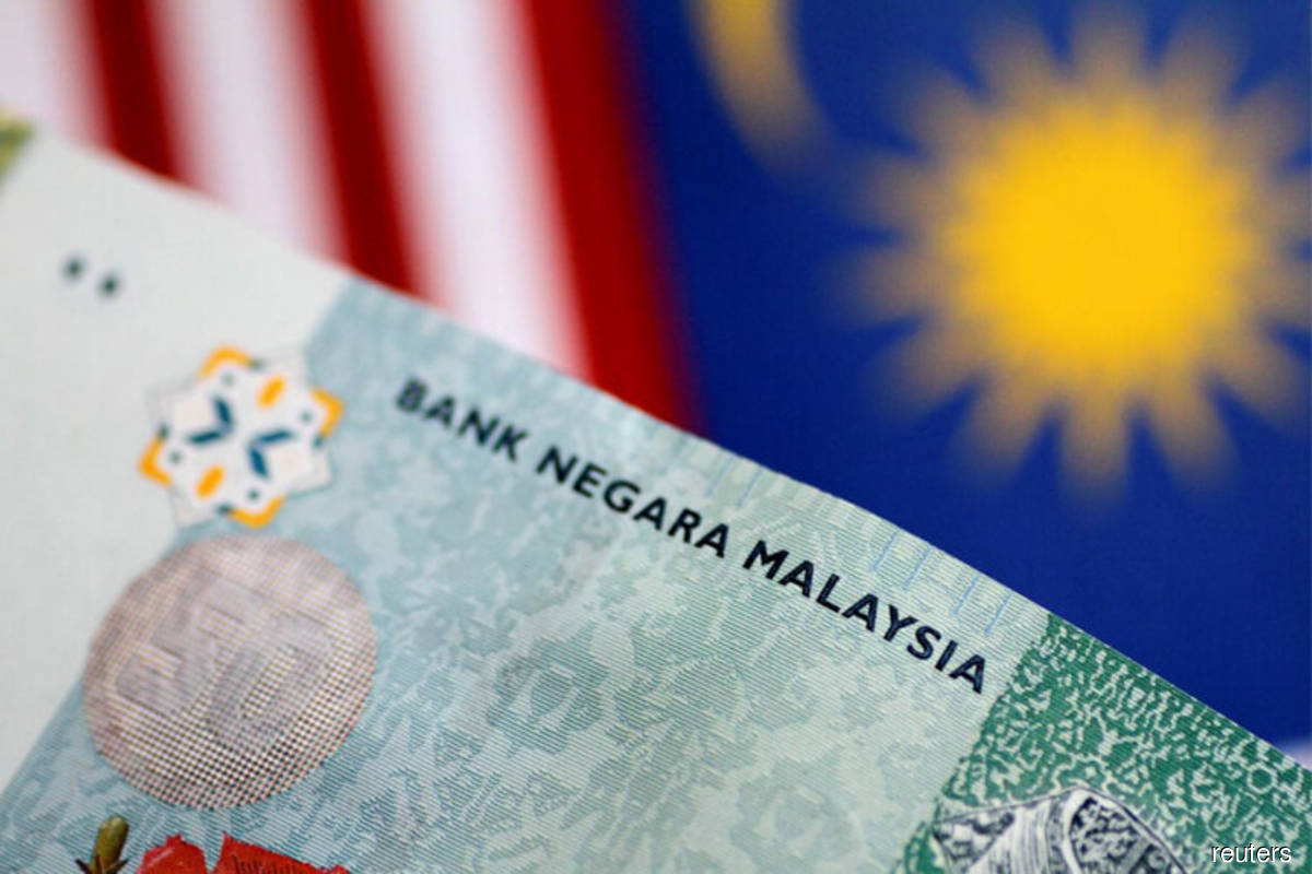Ringgit lower versus US dollar on buying support for greenback
