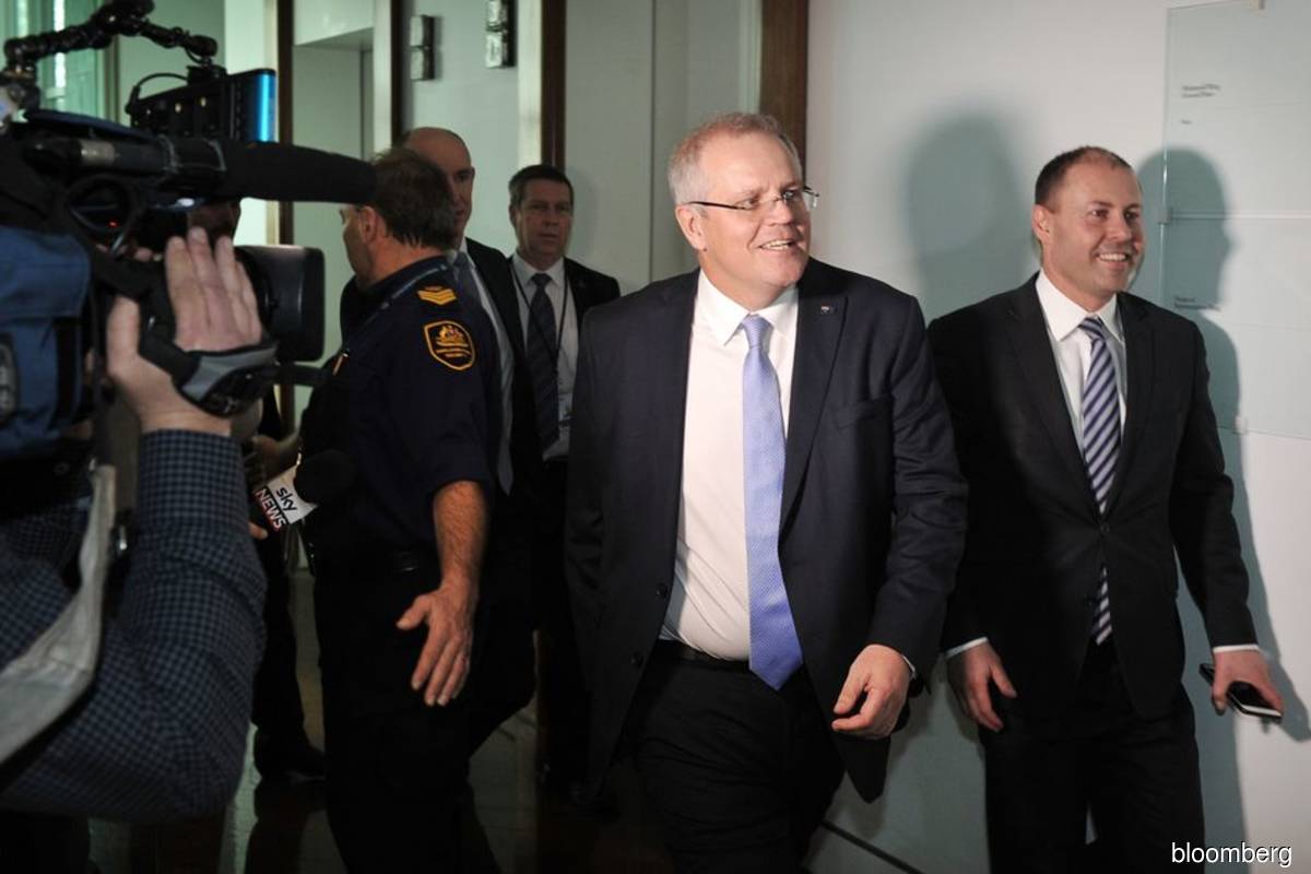 'In hindsight, these arrangements were unnecessary,' Morrison (second from right) admitted in a statement.