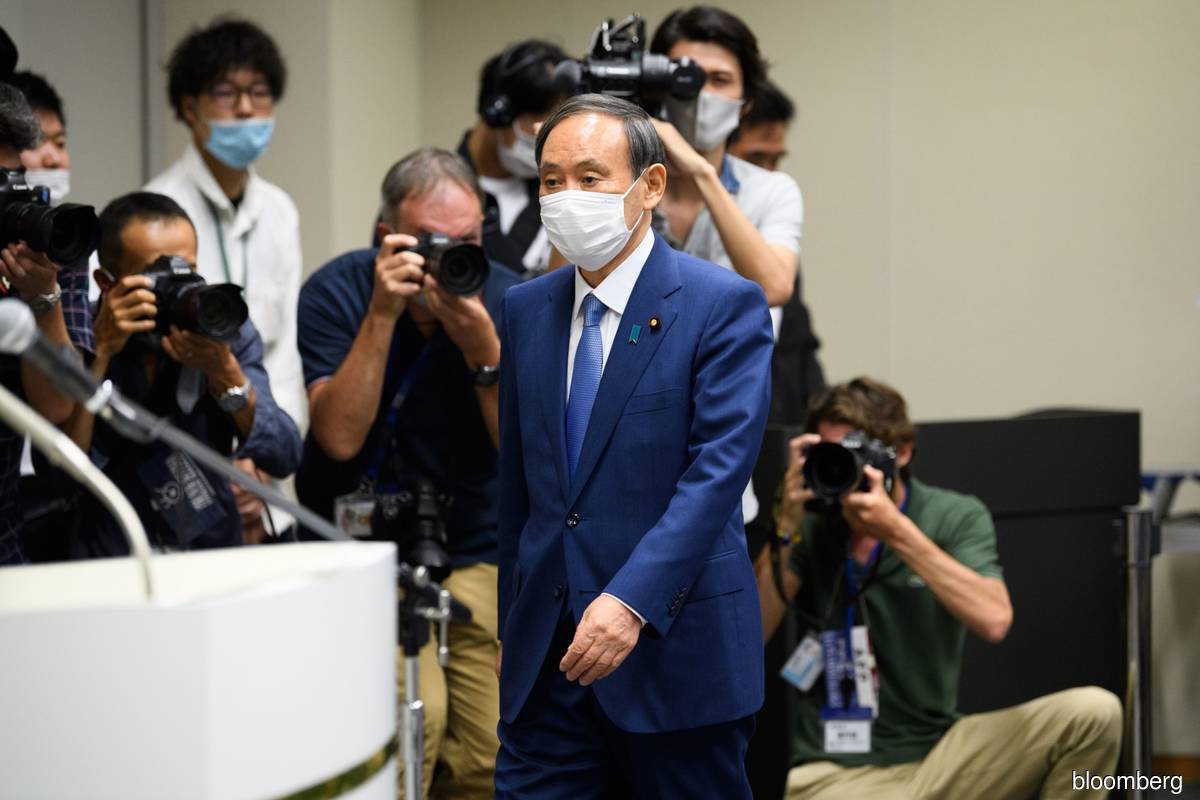 Support for Japan’s Suga slides as latest virus wave worsens