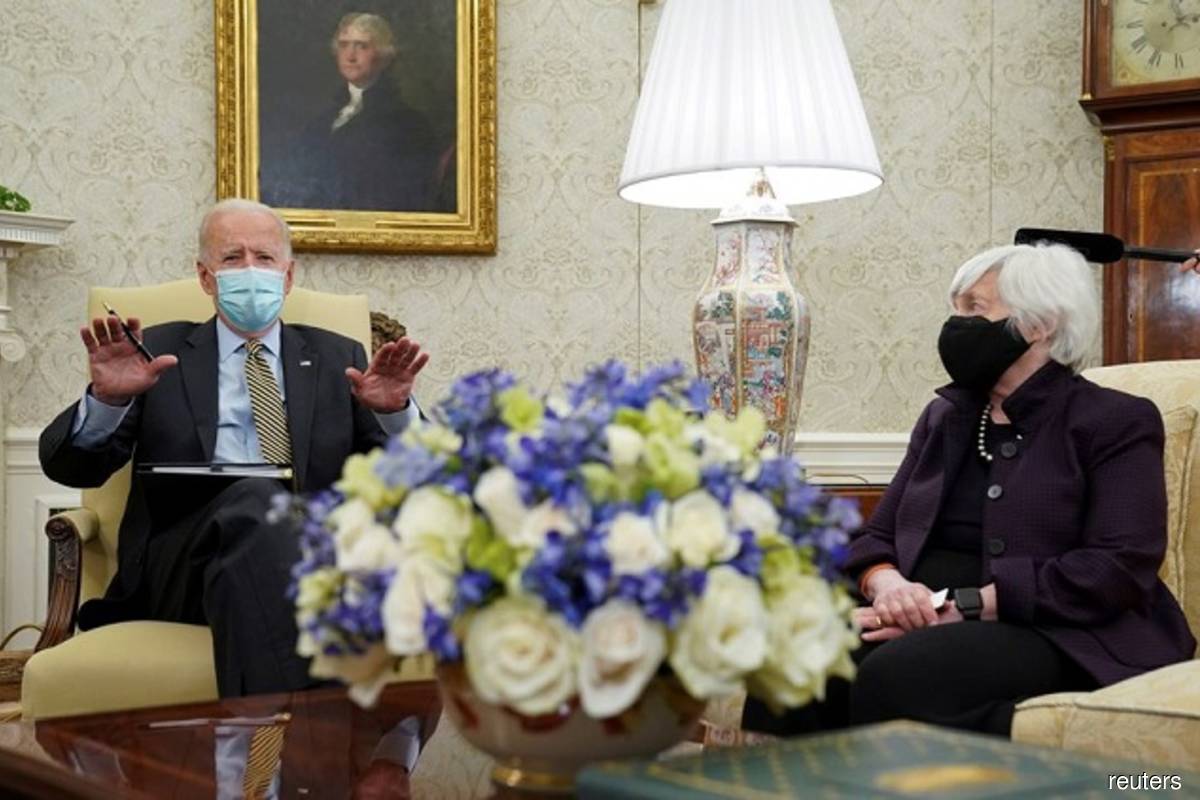 US President Biden wears a mask while he speaks next to US Treasury Secretary Janet Yellen, as he receives the weekly economic briefing at the White House in Washington on April 9, 2021, amidst the Covid-19 pandemic. (Photo by Kevin Lamarque/Reuters filepix)