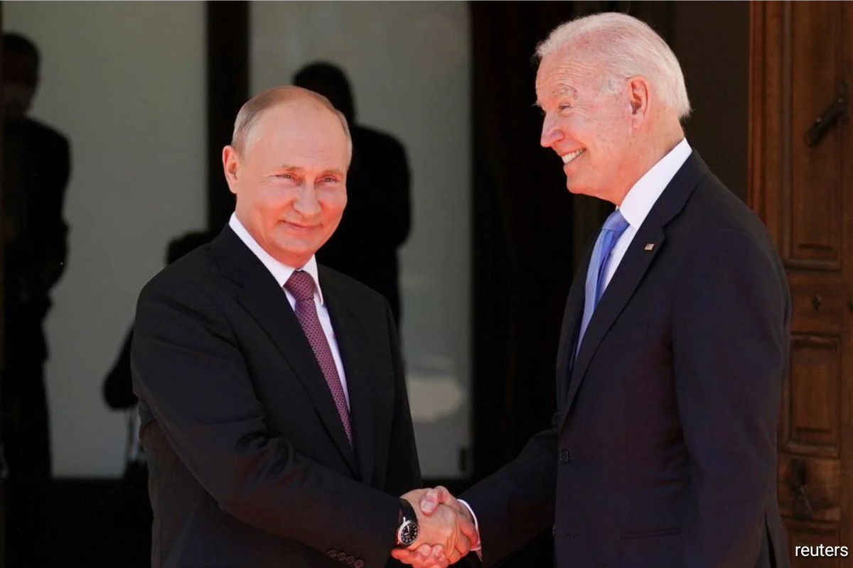 U.S. President Joe Biden and Russia's President Vladimir Putin shake hands as they arrive for the U.S.-Russia summit.