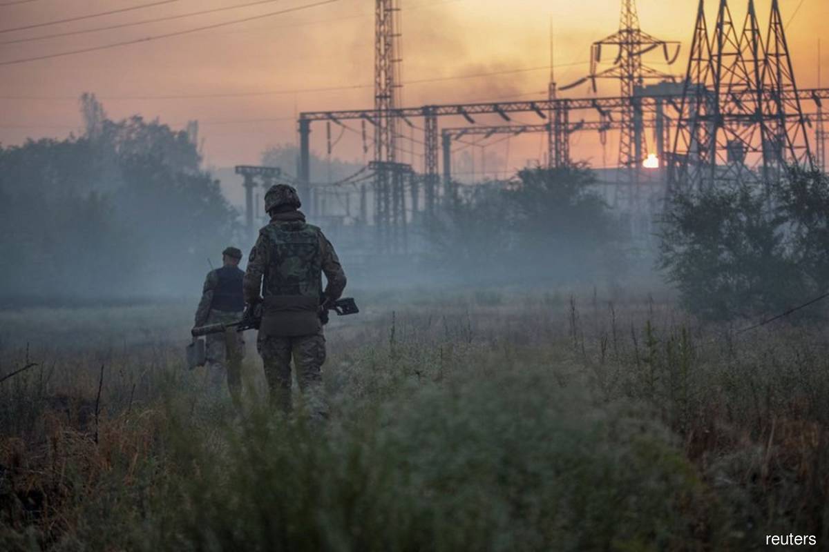 Ukrainian service members patrol an area in the city of Sievierodonetsk, Ukraine on June 20, 2022, as Russia's attack on Ukraine continues. (Reuters filepix by Oleksandr Ratushniak)