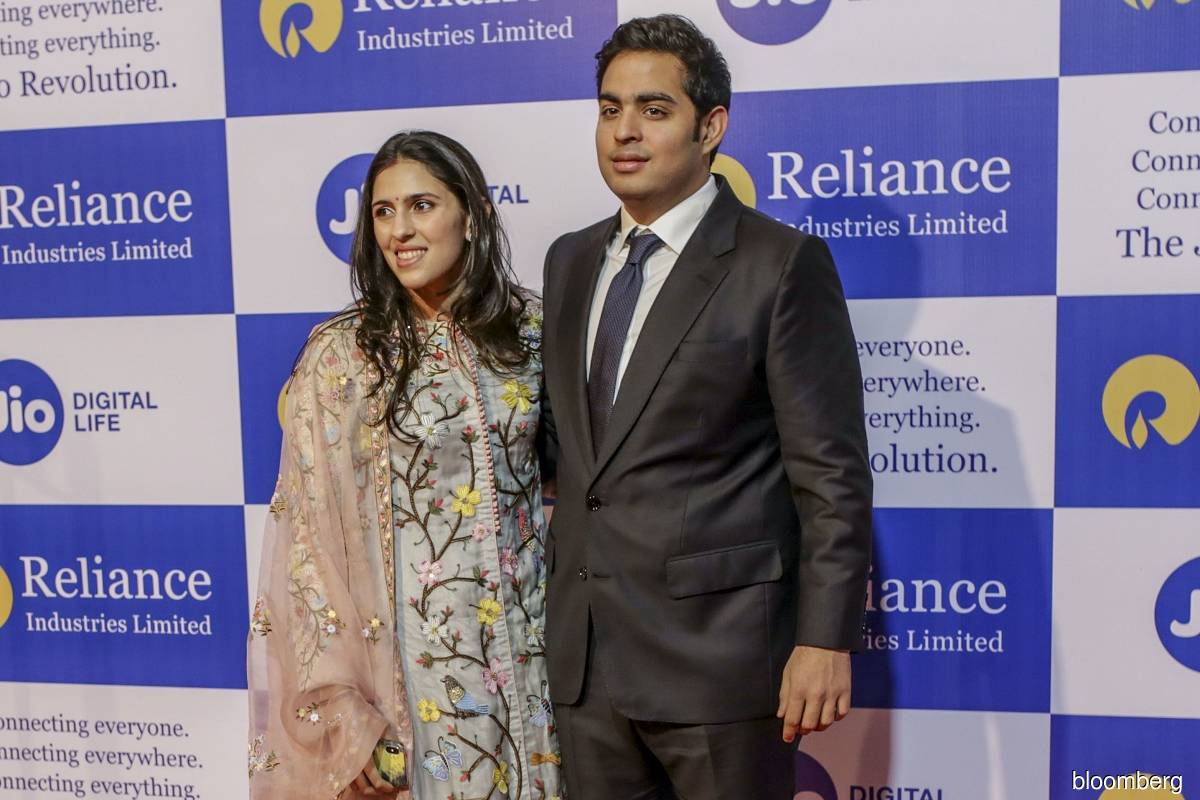 Akash Ambani (right) and his wife Shloka Mehta