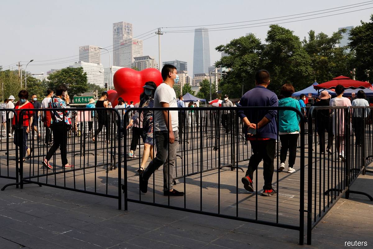 Residents line up for nucleic acid testing at a makeshift testing site near the Central Business District (CBD), amid the Covid-19 outbreak in Beijing, China May 24, 2022.