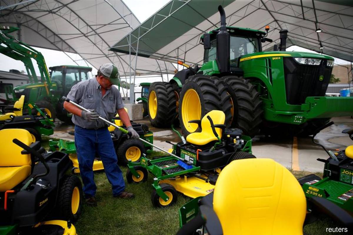 A man cleans farm machinery as people prepare for the Iowa State Fair in Des Moines, Iowa, US on Aug 5, 2019. (Photo by Eric Thayer/Reuters filepix)
