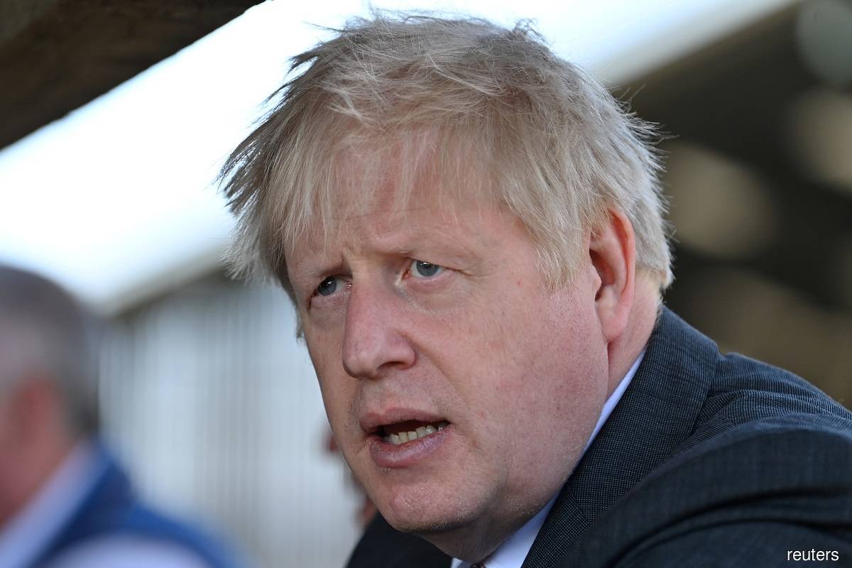 A defiant Johnson says he is staying as UK leader into 2030s