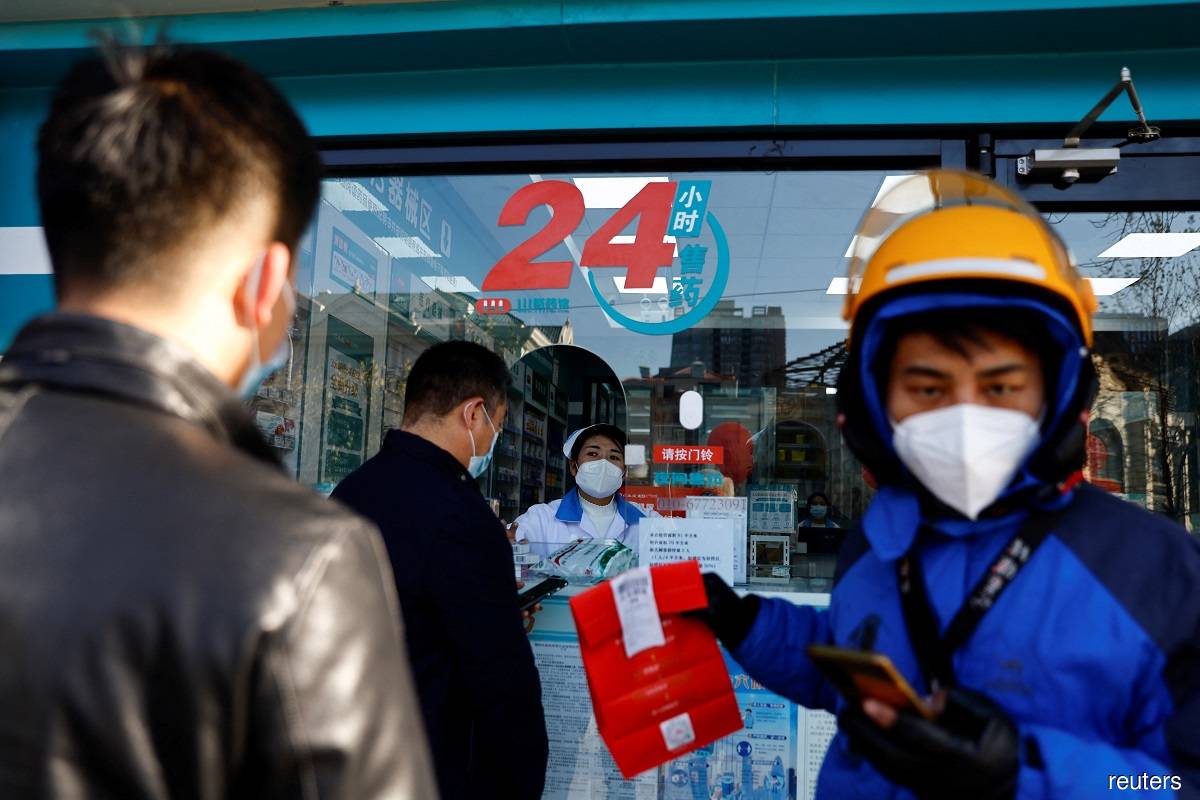 Shoppers seen in a line at a pharmacy in Beijing, China on Dec 6, 2022.