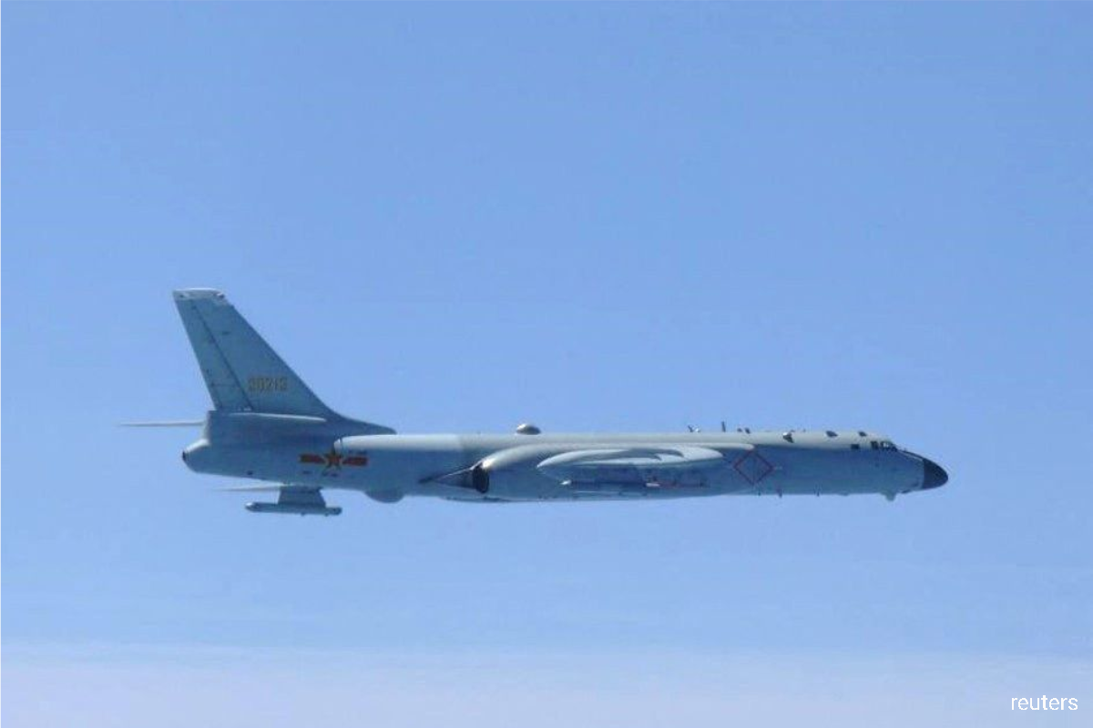 A Chinese H-6 bomber flies over East China Sea in this handout picture taken by Japan Air Self-Defence Force and released by the Joint Staff Office of the Defense Ministry of Japan on May 24, 2022.