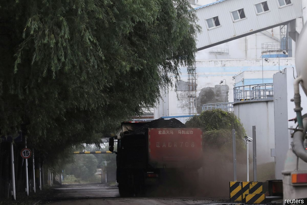A truck transports coal at a coal-fired power plant in Shenyang, Liaoning province, China September 29, 2021.