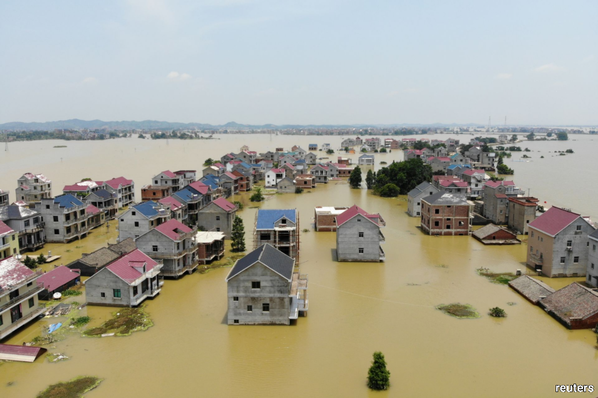 Buildings and farmlands are seen partially submerged in floodwaters following heavy rainfall in Poyang county of Jiangxi province, China July 17, 2020. China Daily via REUTERS