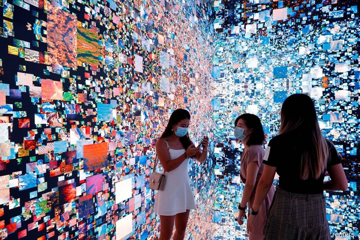 Visitors pictured on Sept 30, 2021 in front of an immersive art installation titled 
