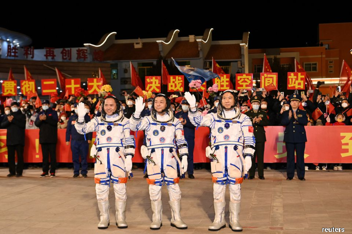 Astronauts Fei Junlong, Deng Qingming and Zhang Lu attending a see-off ceremony before the Shenzhou-15 spaceflight mission to build China's space station, at Jiuquan Satellite Launch Center, near Jiuquan, Gansu province, China on Sept 29, 2022. (cnsphoto via Reuters)