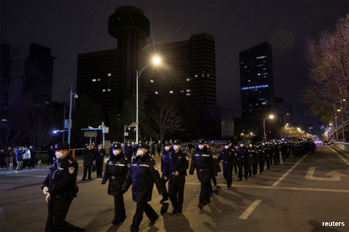 Police arriving at a protest against Covid-19 restrictions after a vigil for the victims of a fire in Urumqi, as outbreaks of Covid-19 continued, in Beijing, China on Monday (Nov 28).