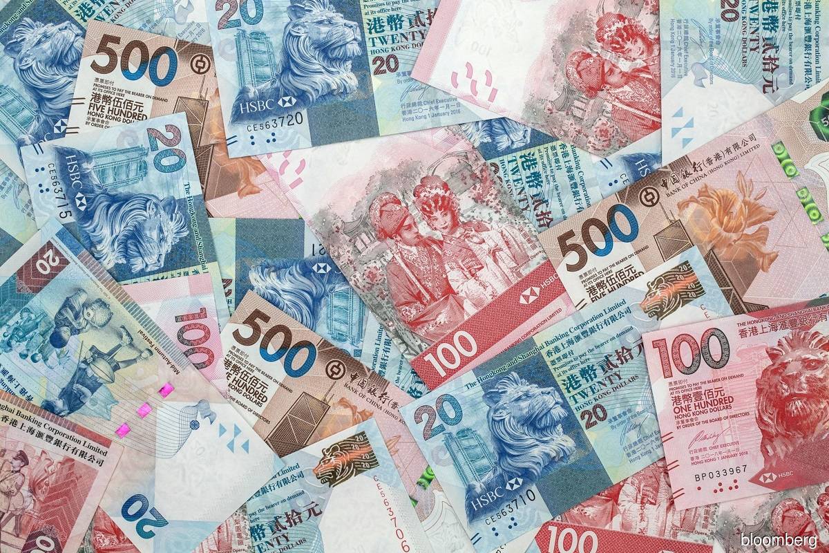 Hong Kong buys local dollars to defend currency peg on greenback