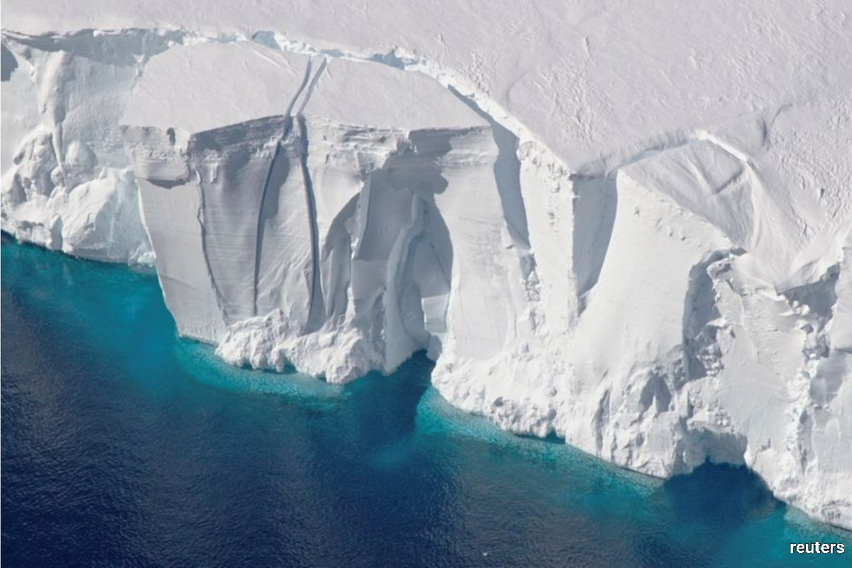 An aerial view of the 200-foot-tall (60-metre-tall) front of the Getz Ice Shelf with cracks, in Antarctica, in this undated handout image. (NASA/Handout via Reuters)