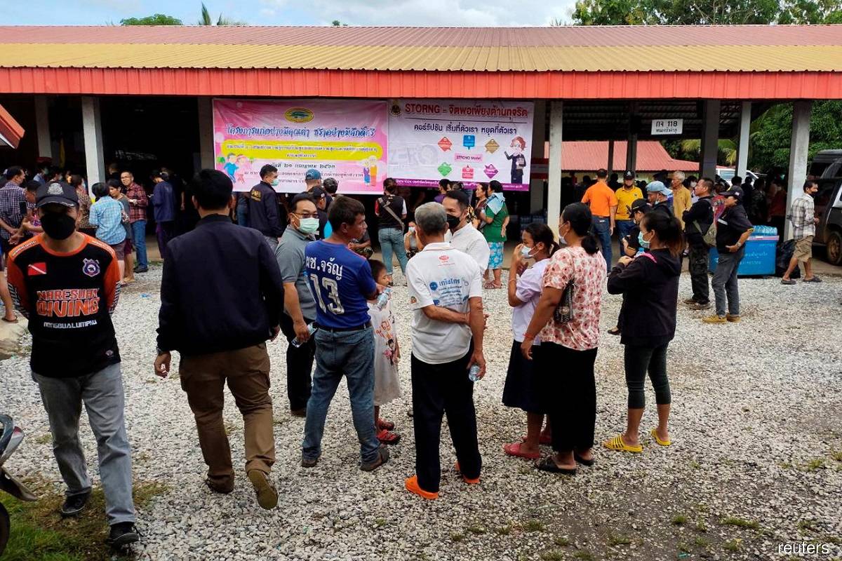 People gather outside of a daycare centre's scene of a mass shooting in the town of Uthai Sawan, 500km northeast of Bangkok in the province of Nong Bua Lamphu, Thailand Oct 6, 2022.
