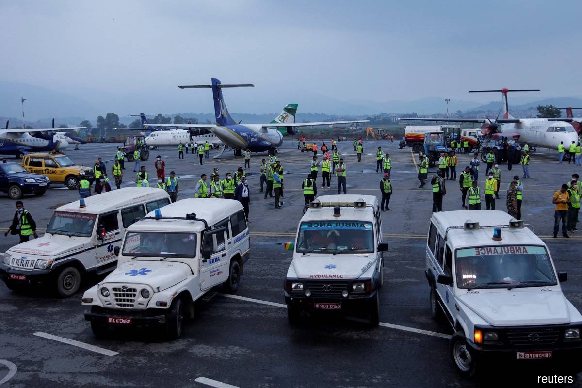 Ambulances carrying remains of victims of the Tara Air passenger plane, that crashed with 22 people on board while on its way to Jomsom, heading towards the morgue from the airport in Kathmandu, Nepal on May 30, 2022.