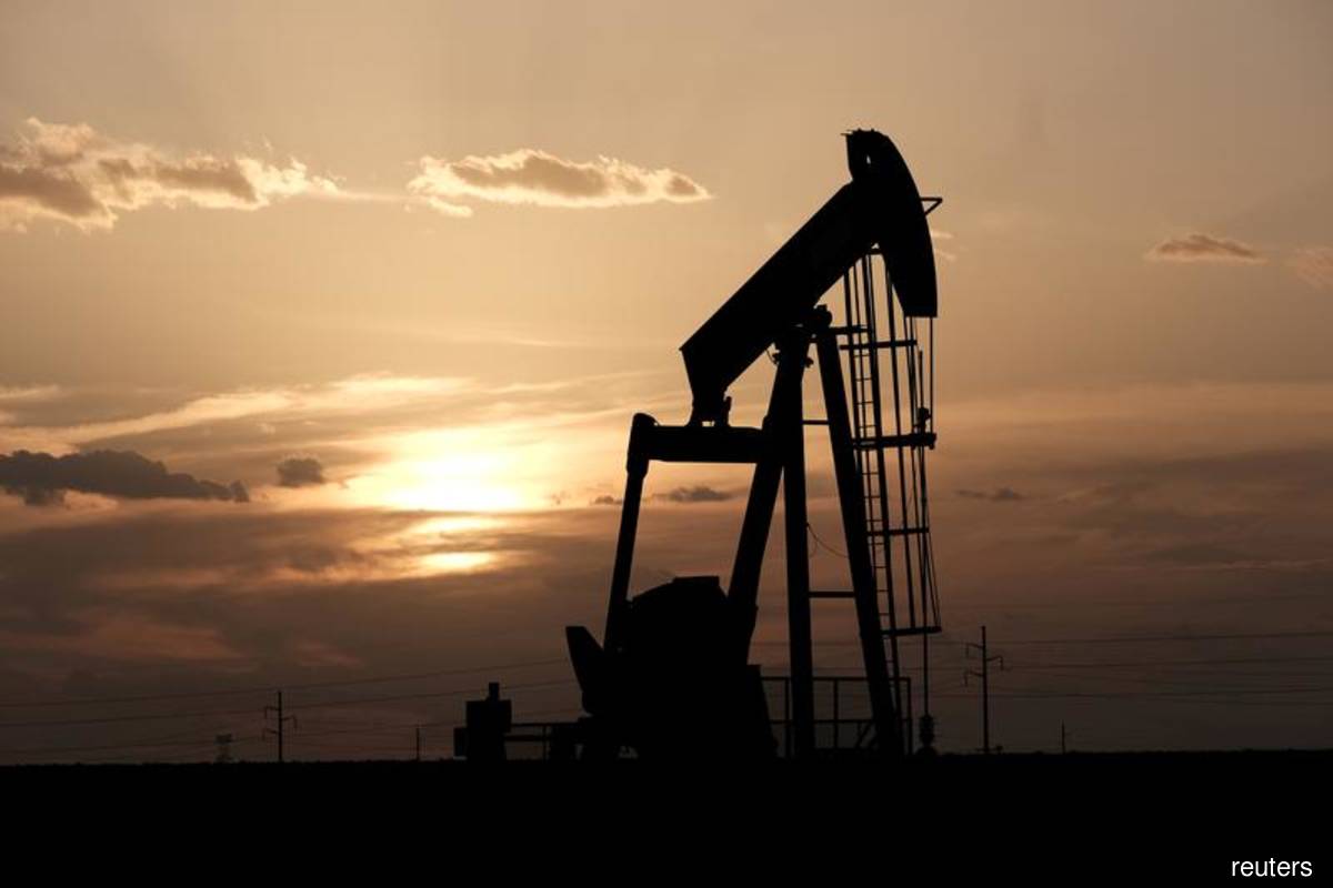 Oil reverses losses on weak US dollar, but China crude reserves sale looms